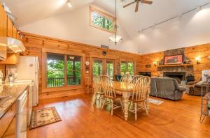 a kitchen and dining room with a table and chairs at Hummingbird Hollow in Bryson City