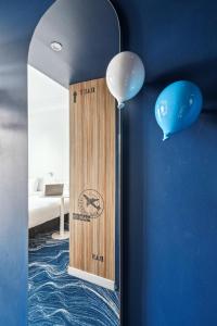 a mirror in a room with balloons and a bedroom at ibis Styles Paris Orly Airport in Paray-Vieille-Poste