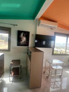 a kitchen with a counter and a table and chairs at LOFT Avec une vue paradisiaque in Imouzzer Kandar