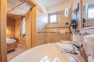 a bathroom with a tub and a sink at Appartamenti Anna in Livigno +69 photos