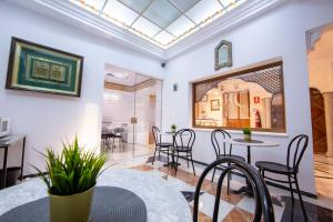 a dining room with a table and chairs at Hotel Los Omeyas in Córdoba +135 photos