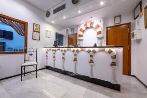 a bar in a room with a chair at Hotel Los Omeyas in Córdoba