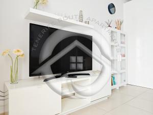a television on a white stand in a room at Janias Alcalà Apartment in Alcalá