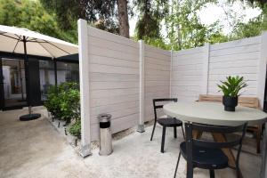 a patio with a white fence and a table and chairs at Luxury rooms 12-2 in Plovdiv