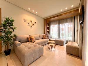 a living room with a couch and a table at Seaside Apartments in Martil