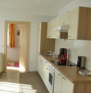 a kitchen with white cabinets and a counter top at Apartment Galtenberg in Alpbach