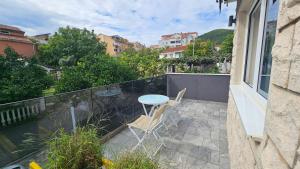 a balcony with a table and chairs on a balcony at Villa Montemaris Budva in Budva