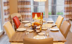 a wooden table with white plates and glasses on it at Seeteufel in Zingst +15 photos