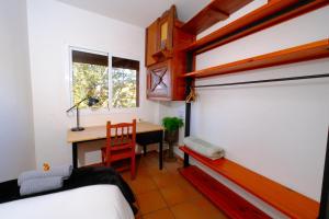 a bedroom with a desk and a bed and a table at Vuelve al Origen - Nómadas Digitales in Tegueste +127 photos