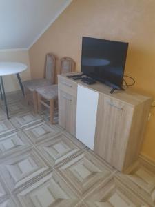 a living room with a tv on top of a refrigerator at Small cute single room A2 in Pancevo in Pančevo +2 photos