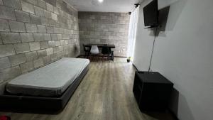 a room with a bed and a table in it at Bonito Departamento en el Centro de Guadalajara in Guadalajara