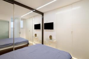 Un dormitorio con una cama y una pared de cristal. en flat Belvedere las canteras beach, en Las Palmas de Gran Canaria