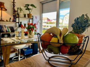 a basket of fruit and vegetables on a table at Stay in Skopje - Prime Location Apartment in Skopje