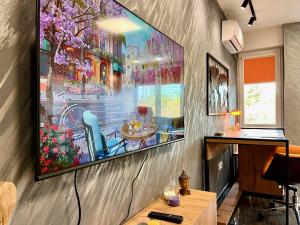 a living room with a painting on the wall at Stay in Skopje - Prime Location Apartment in Skopje