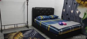 a bed with two pillows on it in a room at Homestay Mak Serting Tengah in Batu Kikir