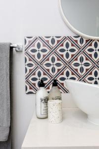 a bathroom with a sink and a mirror at Waddle Inn Luxury apartment in Franschhoek in Franschhoek