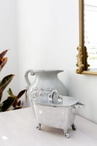 a glass bath tub sitting on a table with a mirror at Waddle Inn Luxury apartment in Franschhoek in Franschhoek +49 photos