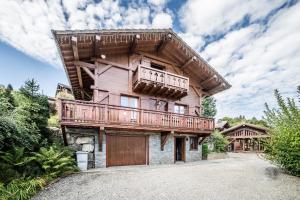 una grande casa in legno con balcone di Chalet familial - Le Laquis a Morillon
