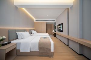 Letto o letti in una camera di 隽雅酒店芙蓉镇景区点