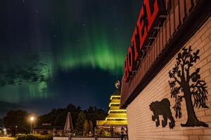 a building with a sign with the aurora in the sky at Jämtkrogen Hotell in Bräcke