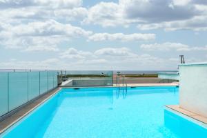 a swimming pool on the roof of a building at Nemea Appart Hotel Nice Arenas Aéroport in Nice