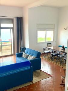 a living room with a blue couch and a table at Panoramica Atlantic Villa Souss-Massa in Rbat +77 photos