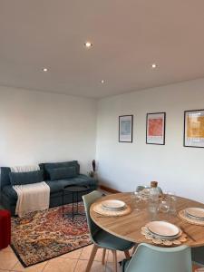 a living room with a table and a couch at Le paisible in Oullins