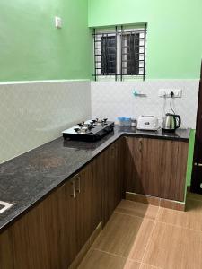 eine Küche mit einem Herd auf einer Theke in der Unterkunft Sri Bairav Cottage in Madurai