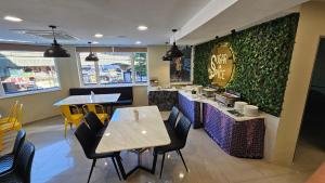 a dining room with tables and chairs in a restaurant at Hotel Ambassador @ Bukit Bintang in Kuala Lumpur