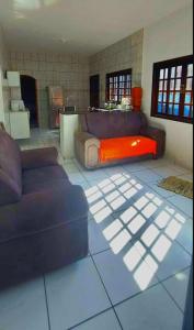 a living room with a couch and a table at Casa Bertioga Boracéia in Bertioga