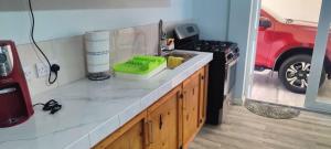 a kitchen with a counter with a sink and a stove at Ti Kai Nous in Roger