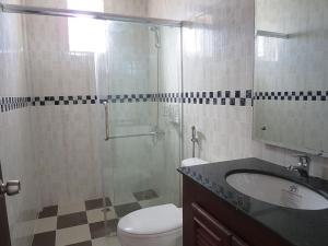 a bathroom with a shower and a toilet and a sink at ST Apartment in Phnom Penh