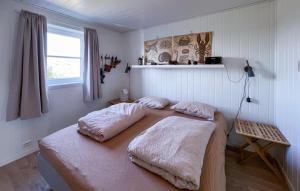 a bedroom with two pillows on a bed at 3 Bedroom Gorgeous Home In Lyngdal in Lyngdal