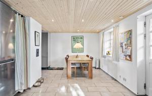 a dining room with a wooden table and chairs at 4 Bedroom Gorgeous Home In Nørre Alslev in Nørre Alslev
