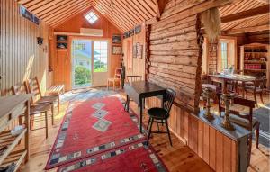 a room with a table and chairs in a log cabin at 2 Bedroom Lovely Home In Lindesnes in Lonestranda