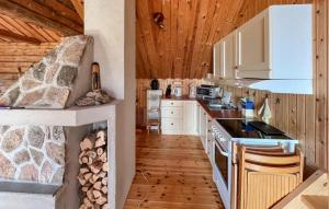 a kitchen with a stove top oven next to a counter at 2 Bedroom Lovely Home In Lindesnes in Lonestranda