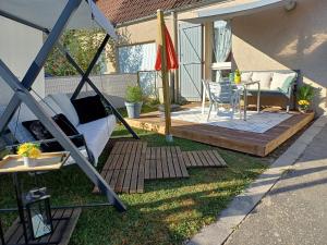 a backyard with a patio with a table and a chair at Maison de la Loue" in Saint-Yrieix-la-Perche