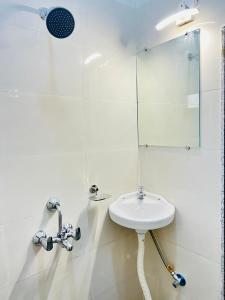 a white bathroom with a sink and a mirror at Agariya Pool Villa near Lake pichola in Udaipur +10 photos