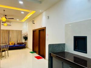 a living room with a television and a living room with a couch at Agariya Pool Villa near Lake pichola in Udaipur