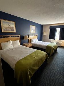 a hotel room with two beds and a window at Ameristay Inn & Suites in Waverly