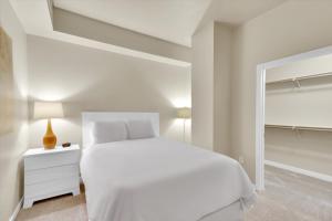 a white bedroom with a white bed and a mirror at Global Luxury Suites Midtown Atlanta in Atlanta +26 photos