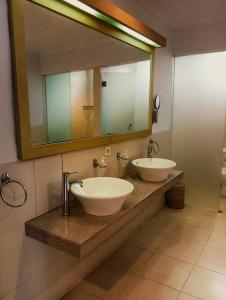 a bathroom with two sinks and a large mirror at BrightUp Villa Beach Side Sanur in Sanur +29 photos