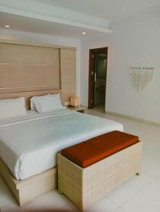a bedroom with a large bed in a room at BrightUp Villa Beach Side Sanur in Sanur