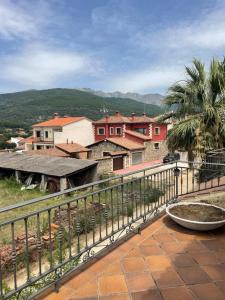 a balcony with a fence and some houses at La Casita del Cerro in Candeleda