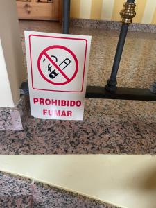 a sign on a floor that reads prohibited indoor fountain at La Casita del Cerro in Candeleda
