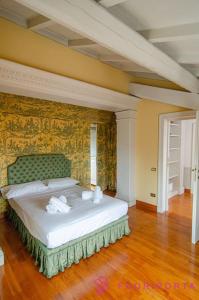 a bedroom with a large bed in a room at Le Belle Époque in Parma