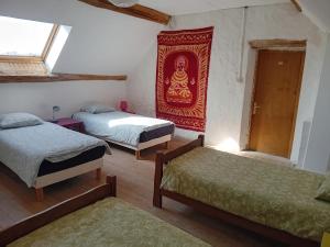 a room with two beds and a painting on the wall at La Ferrière in Marolles-en-Brie +9 photos