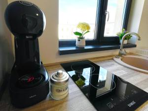 a black coffee maker sitting on a counter next to a counter sidx sidx at Residence 7 De Lux ! in Ploieşti