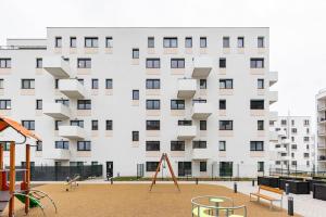 a playground in front of a large building at Flat 3 Sunny Haven Moderny 2i, Parking, WiFi in Bratislava