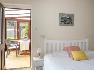 a bedroom with a bed and a table with a chair at The Wellington in Pwllheli